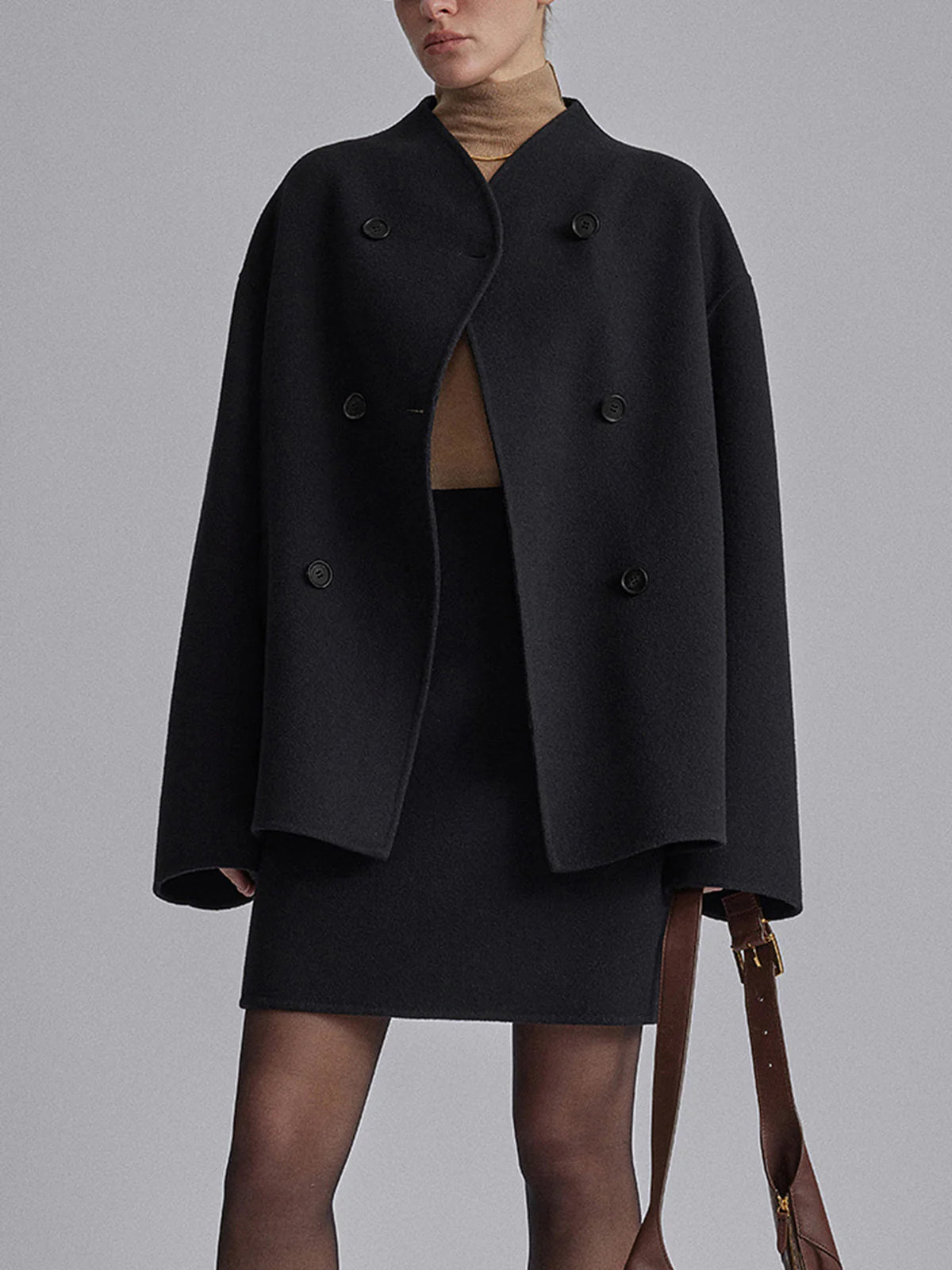 Women's black double-breasted pea coat with horn buttons and notched collar
