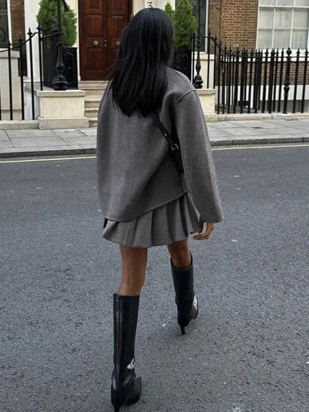 Taupe women's double-breasted pea coat shown from the back with dark button line