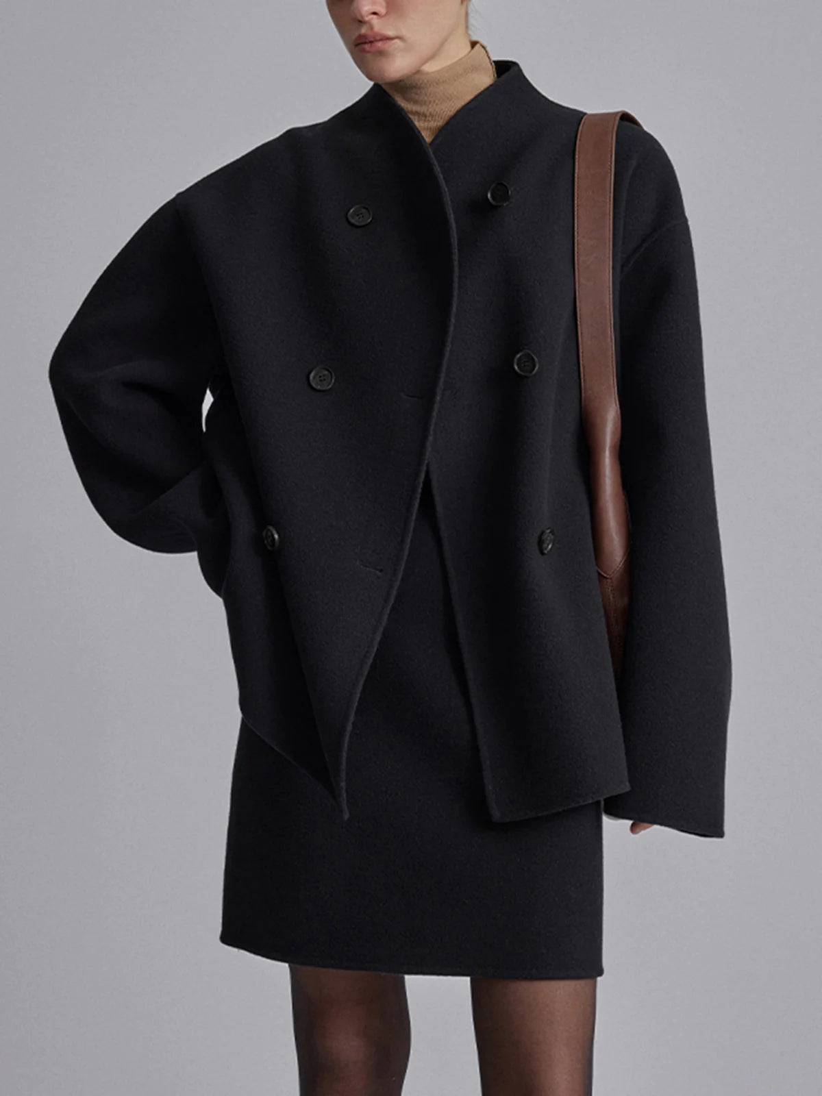 Black women's double-breasted pea coat with dark buttons and tailored cropped silhouette