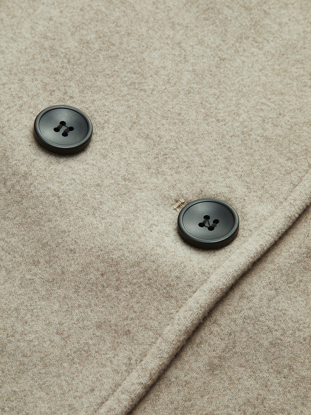 Taupe pea coat fabric with dark double-breasted buttons, round button details visible