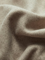 Taupe textured wool-like fabric detail on a double-breasted pea coat