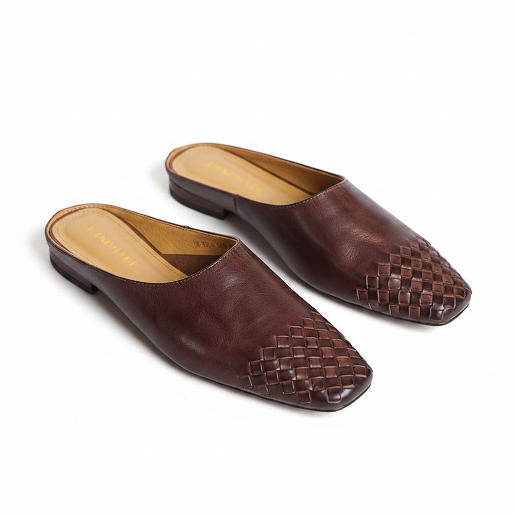 Pair of brown leather slip-on mules with woven square toe design and low heel