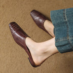 Women’s brown woven leather mule with slip-on loafer styling and low heel
