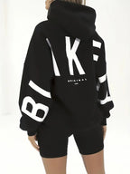 Women’s black hooded jacket with hooded back and bold white graphic lettering