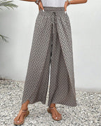 Women’s smocked waist palazzo trousers, dark gray allover print with wide flared legs