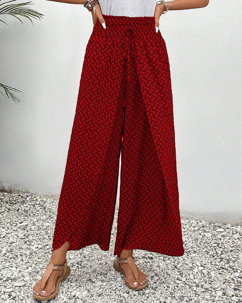 Women’s smocked waist palazzo trousers, bold red allover print with wide flared legs