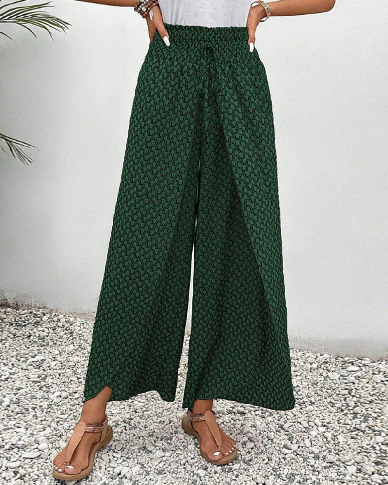 Women’s smocked waist palazzo trousers, deep green allover print with wide flared legs
