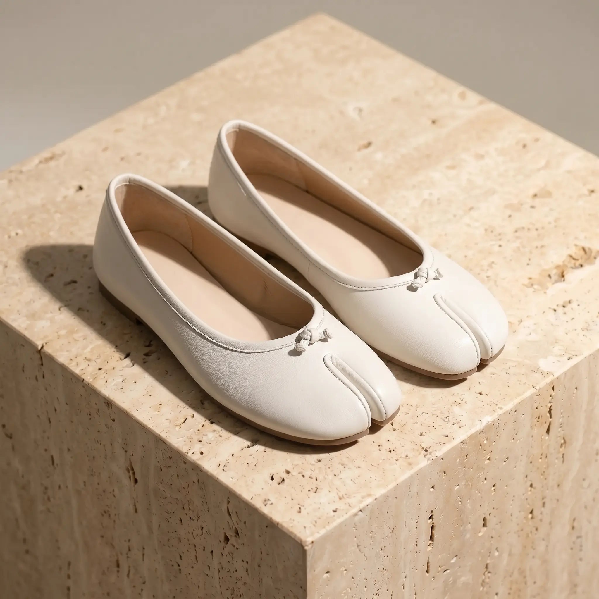 Women's split-toe ballet flats in ivory white with micro-bow detail, flat slip-on