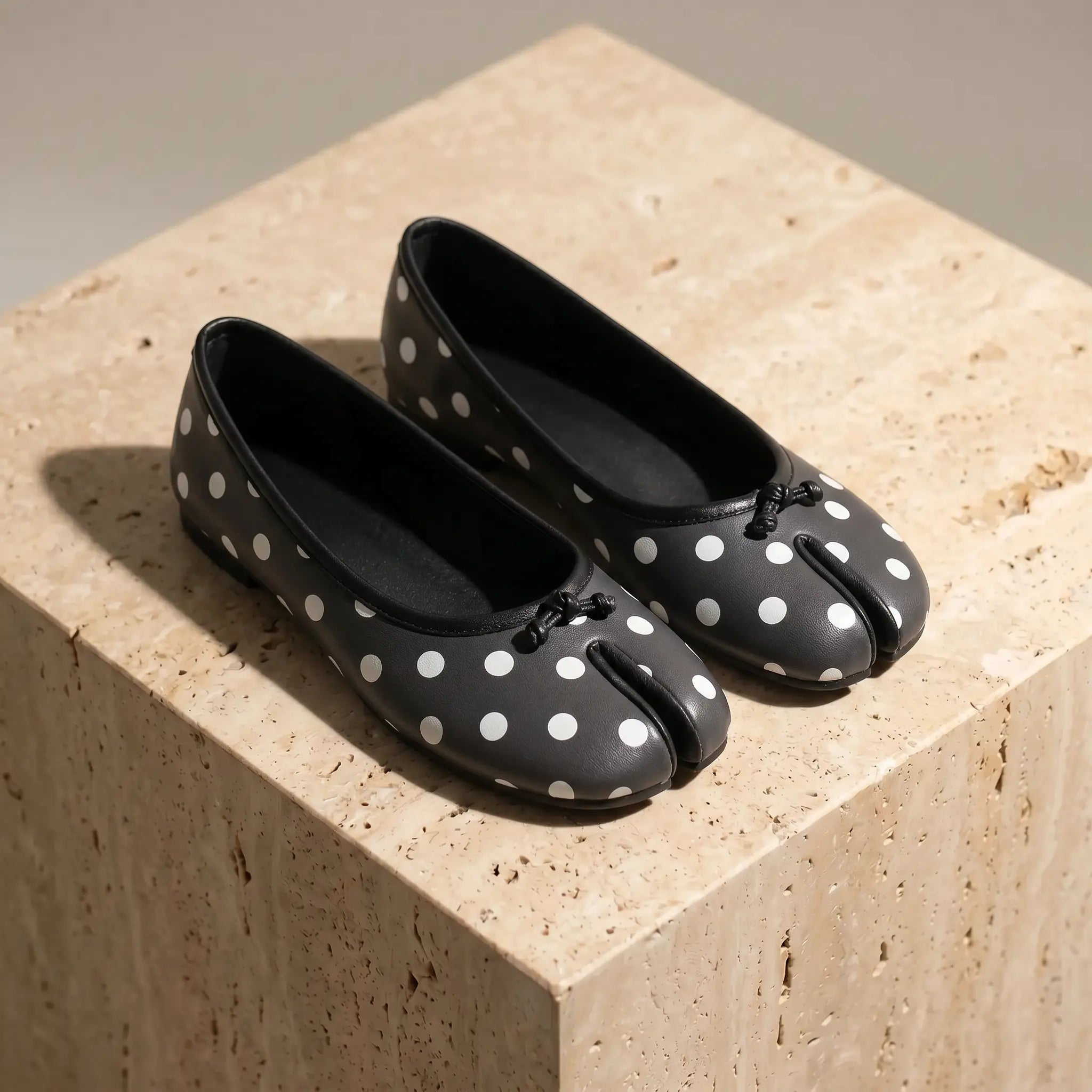Women's split-toe ballet flats in black with white polka dots and micro-bow detail