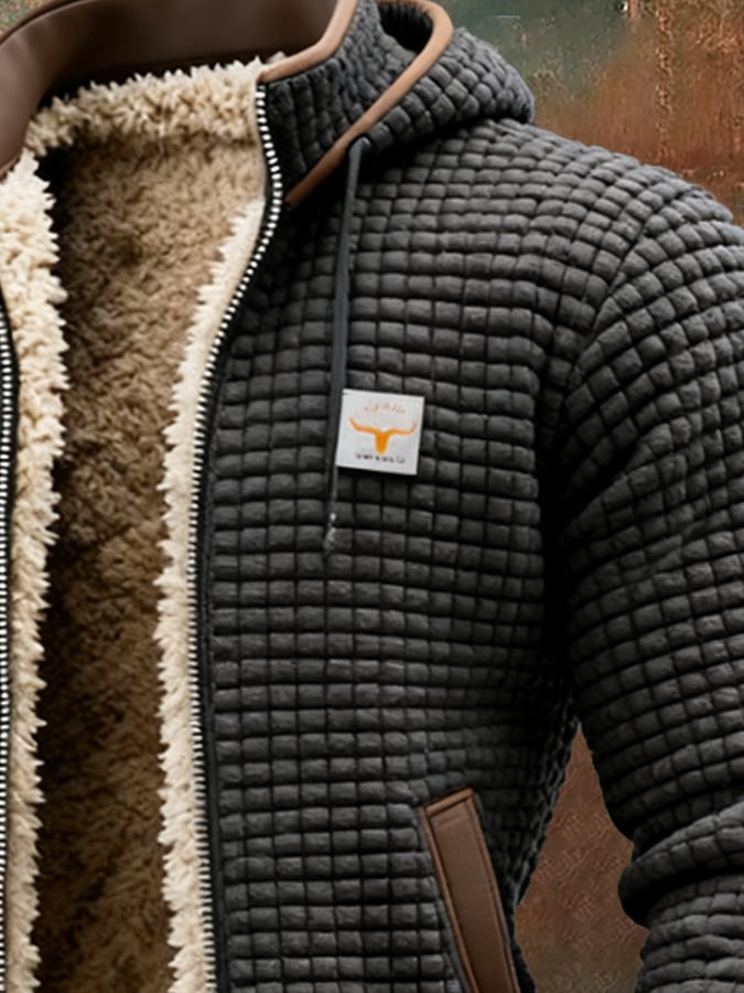 Black quilted insulated fleece jacket close-up with sherpa-lined collar and chest logo patch