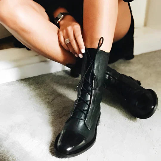 Women’s black lace-up calf boots with glossy finish, laces, and pull-on tabs