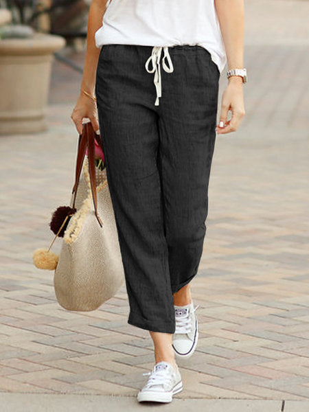 Black women’s tulip-hem lantern trousers with drawstring waist and relaxed fit