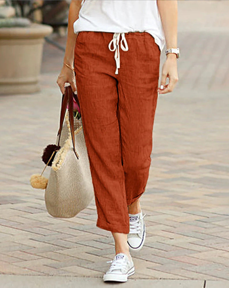Rust red women’s tulip-hem lantern trousers with drawstring waist and relaxed fit