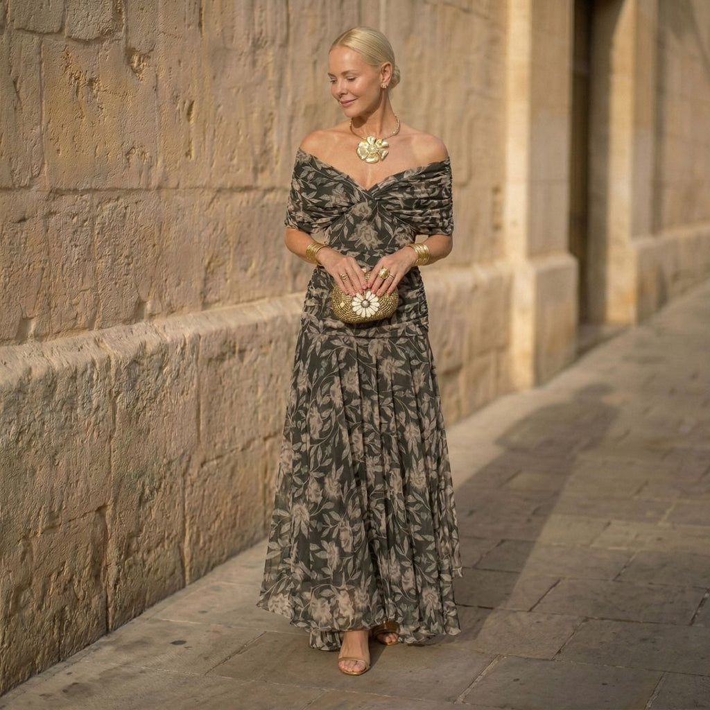 Women's off-shoulder pleated maxi dress with draped neckline, dark botanical print