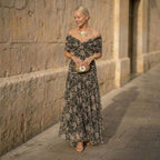 Women's off-shoulder pleated maxi dress with draped neckline, dark botanical print