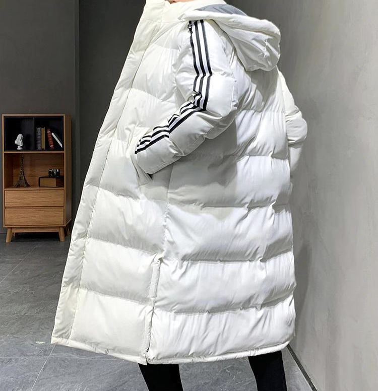 White long hooded puffer jacket with quilted panels and black striped sleeve detail