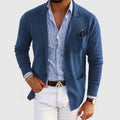 Men's blue blazer with notch lapels, chest pocket holding a pen, side pockets.