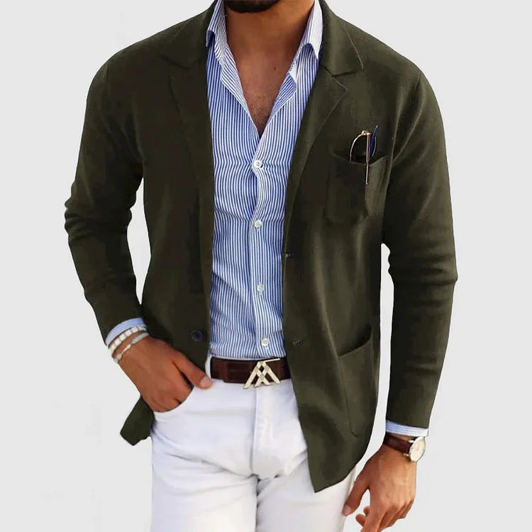 Men's dark green blazer with notch lapels, chest pocket holding a pen, side pockets.