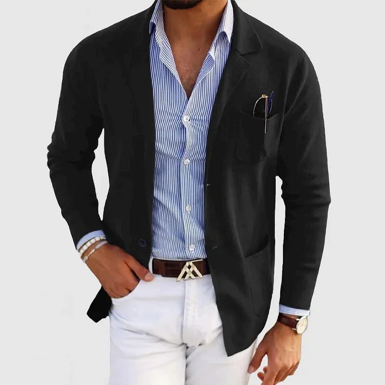 Men's black blazer with notch lapels, chest pocket holding a pen, side pockets.