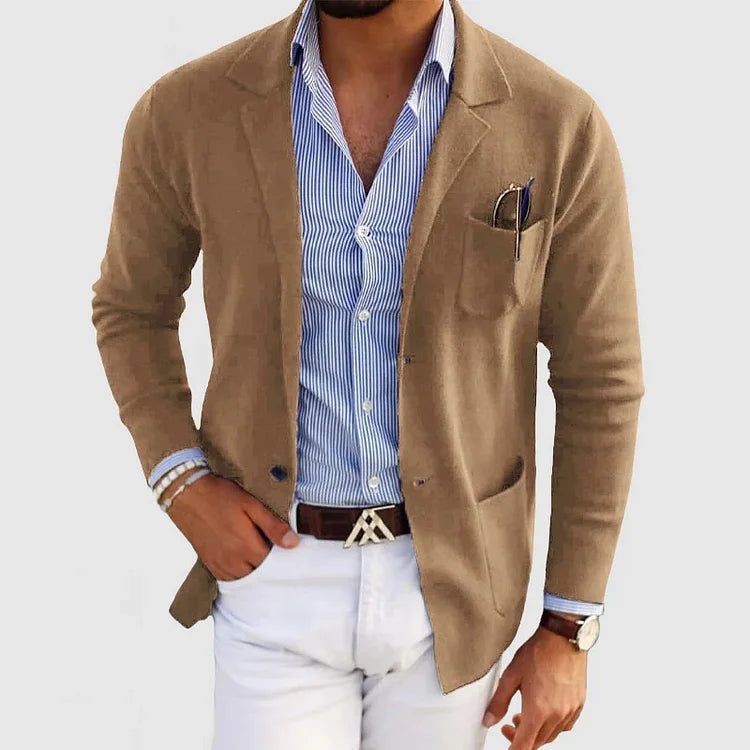 Men's beige blazer with notch lapels, chest pocket holding a pen, side pockets.