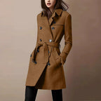 Brown double-breasted belted wool coat with peaked lapels and mid-thigh length, buttoned