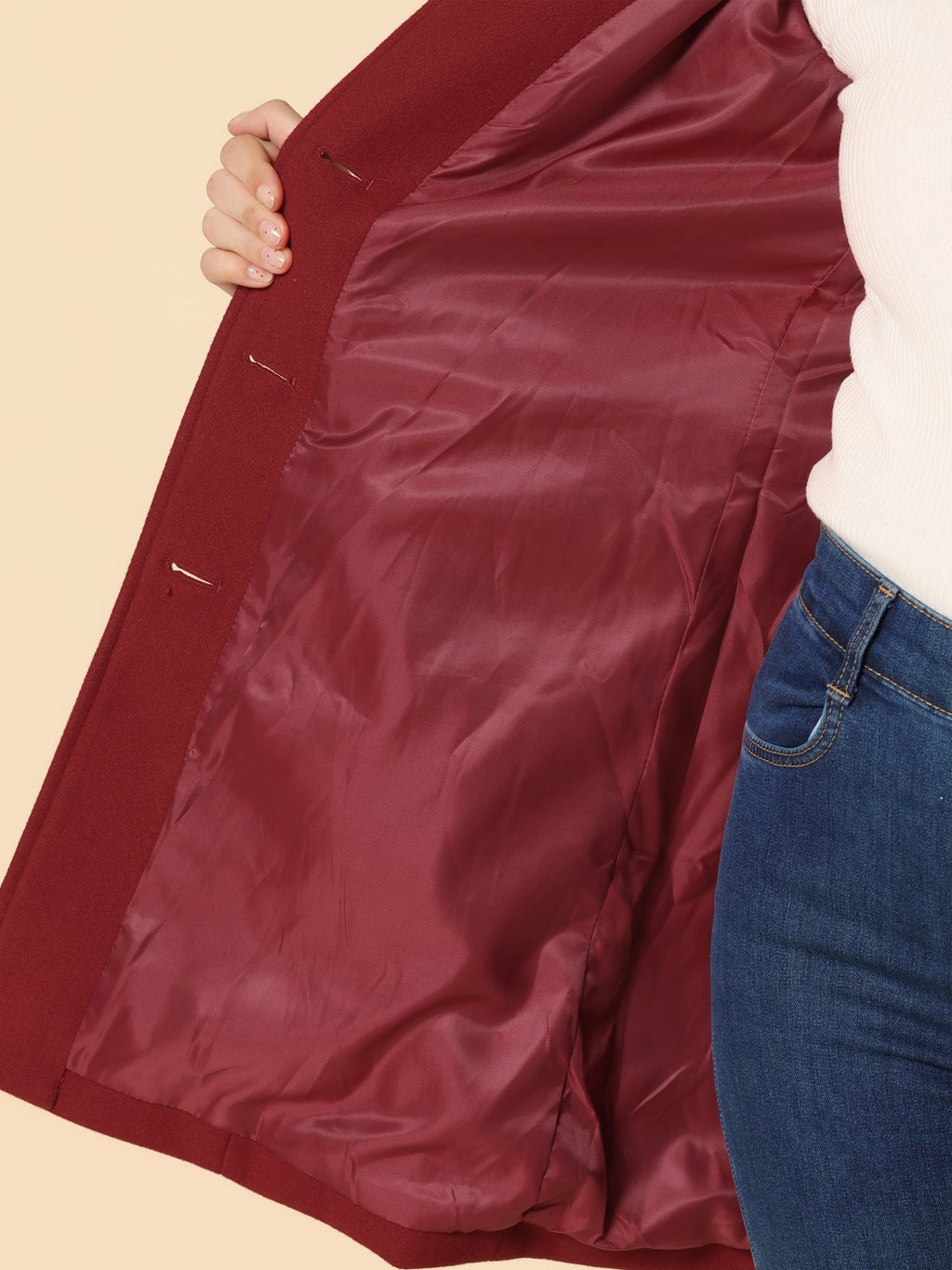 Dark red coat interior lining detail with smooth fabric and seam stitching