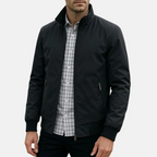 Men's black windbreaker jacket with full zip, stand collar, and zip pockets.