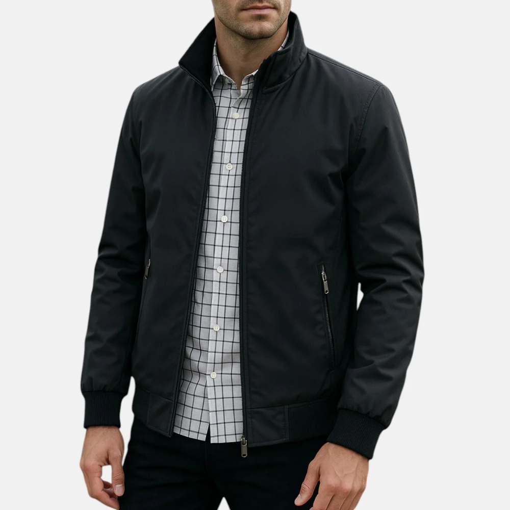 Men's black windbreaker jacket with full zip, stand collar, and zip pockets.