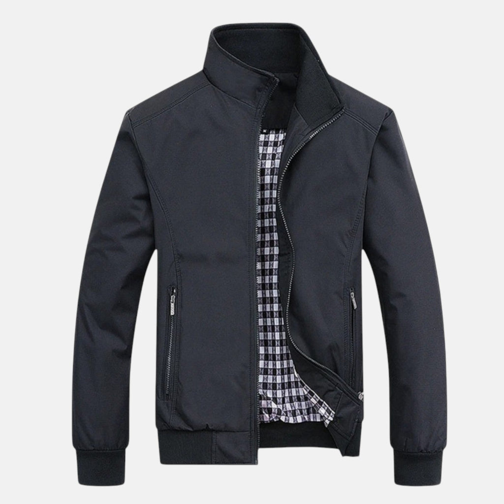 Men's dark windbreaker jacket with full zip, stand collar, and two front zip pockets.
