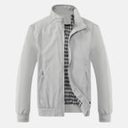Men's white windbreaker jacket with full zip, stand collar, and two front zip pockets.
