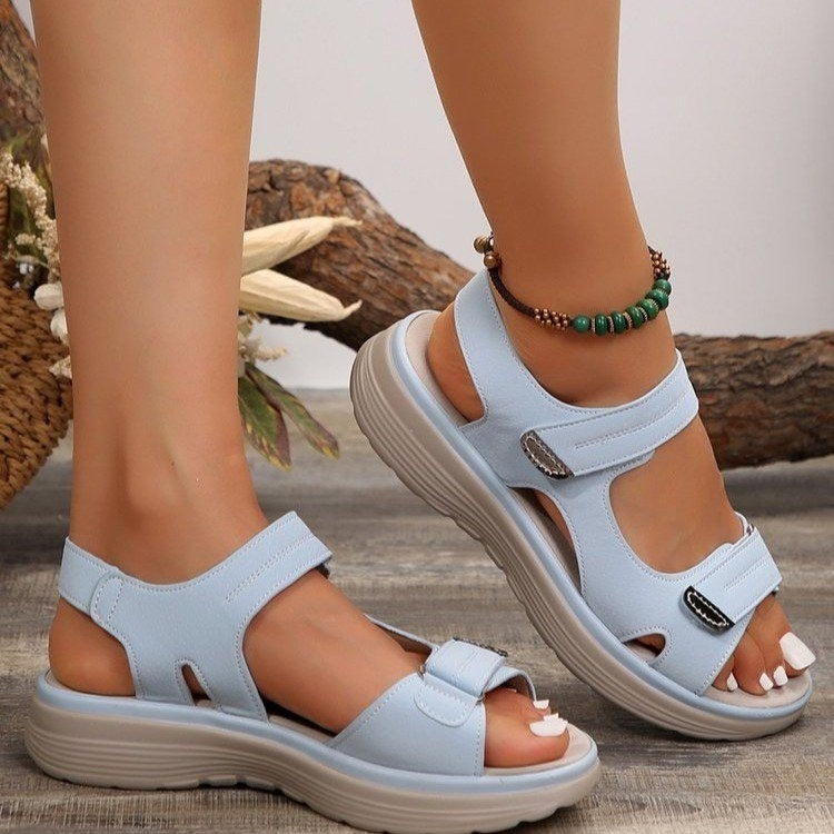 Women's light blue open-toe slide sandals with adjustable straps and cushioned sole