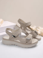 Women's light gray open-toe slide sandals with adjustable straps and cushioned sole
