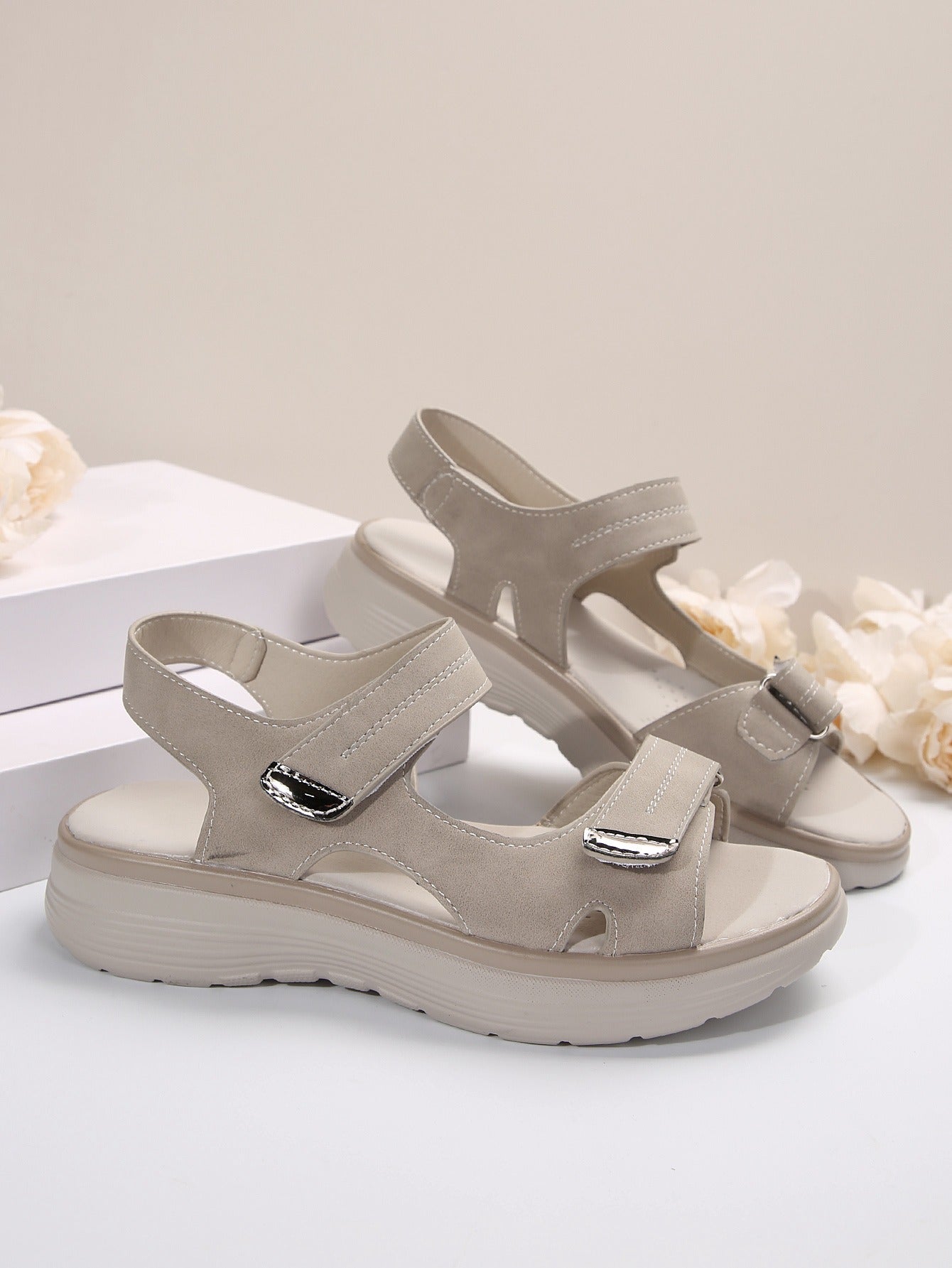 Women's light gray open-toe slide sandals with adjustable straps and cushioned sole