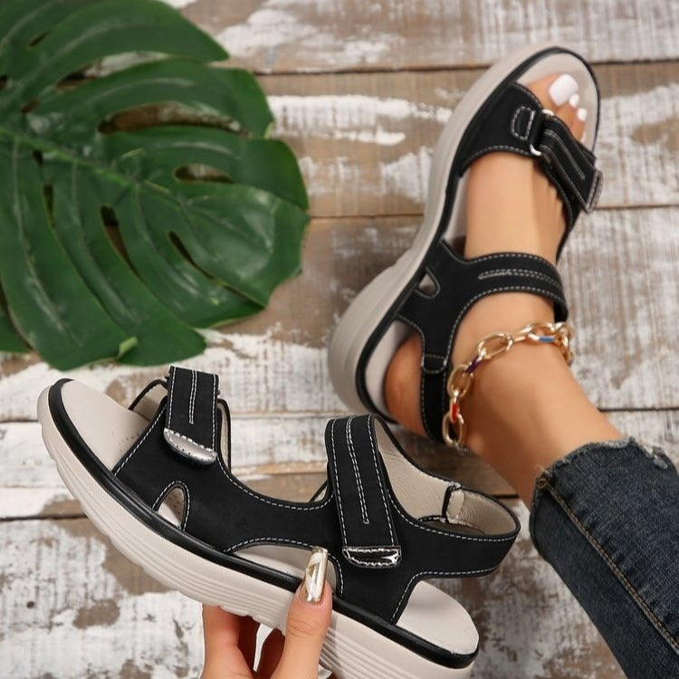 Women's black open-toe slide sandals with adjustable ankle strap and cushioned footbed