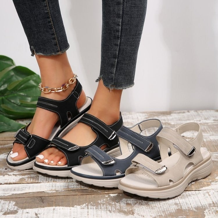Women's open-toe slide sandals with adjustable straps in black and beige tones