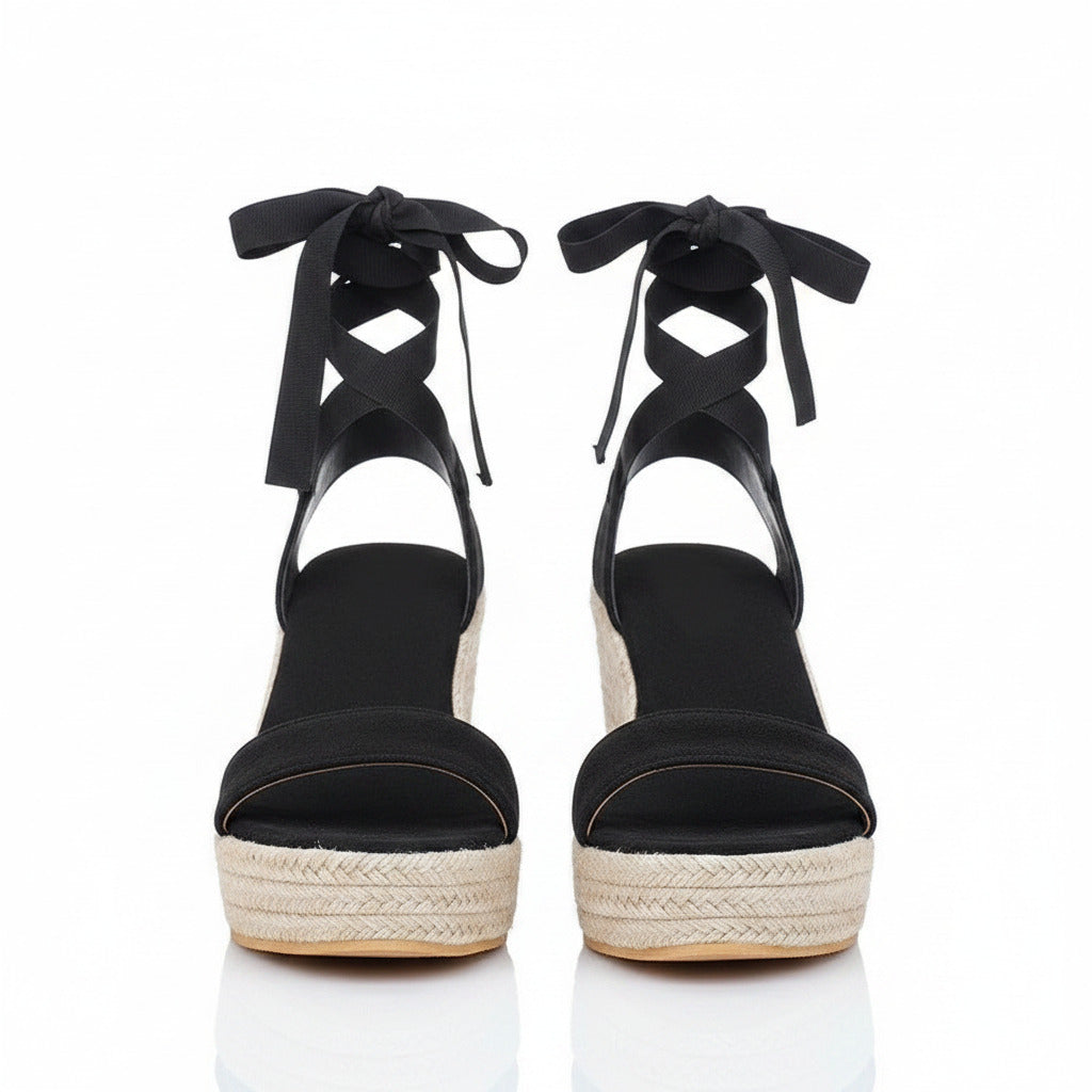 Black lace-up wedge sandals with crisscross ankle straps, peep-toe platform