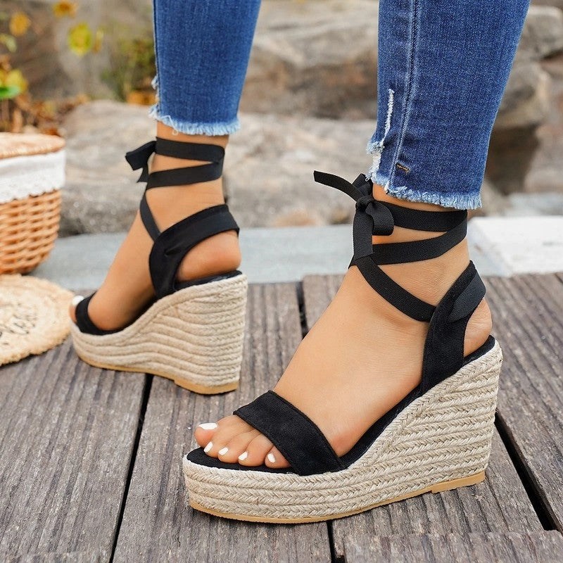 Black espadrille wedge sandals with ankle lace straps and platform sole, side view