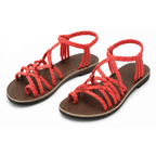 Red flat thong sandals, open toe with braided lace straps and tassel ties.