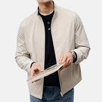 Beige men's casual jacket with stand-up collar and front zip, side view.
