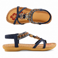Women’s navy sandal with cushioned sole, ankle strap, and ornamental bead trim