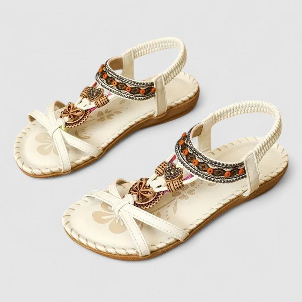 White orthopedic cushioned strap sandals with floral pattern and ornate dangling charms