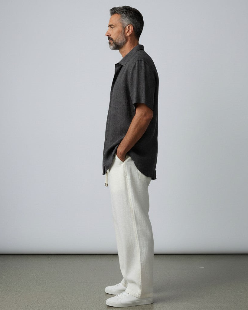 Men's linen shirt in black, short-sleeve button-up with side profile view