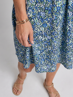 Blue tropical print dress with elastic waist and gathered knee-length skirt