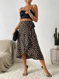 Women's black midi wrap skirt with asymmetrical hem, allover cream leaf print