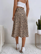 Women's brown midi wrap skirt with asymmetrical hem, small dark animal print