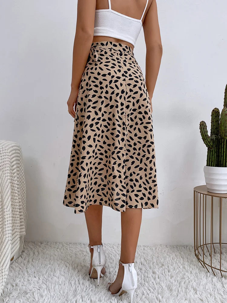 Women's brown midi wrap skirt with asymmetrical hem, small dark animal print