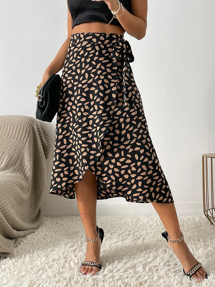 Women's black midi wrap skirt with asymmetrical hem, beige leaf patterned print