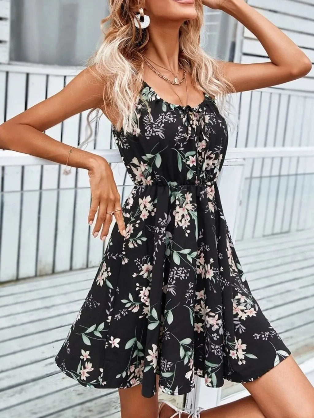 Women’s black floral mini dress with thin straps and ruched tie-shoulder bodice