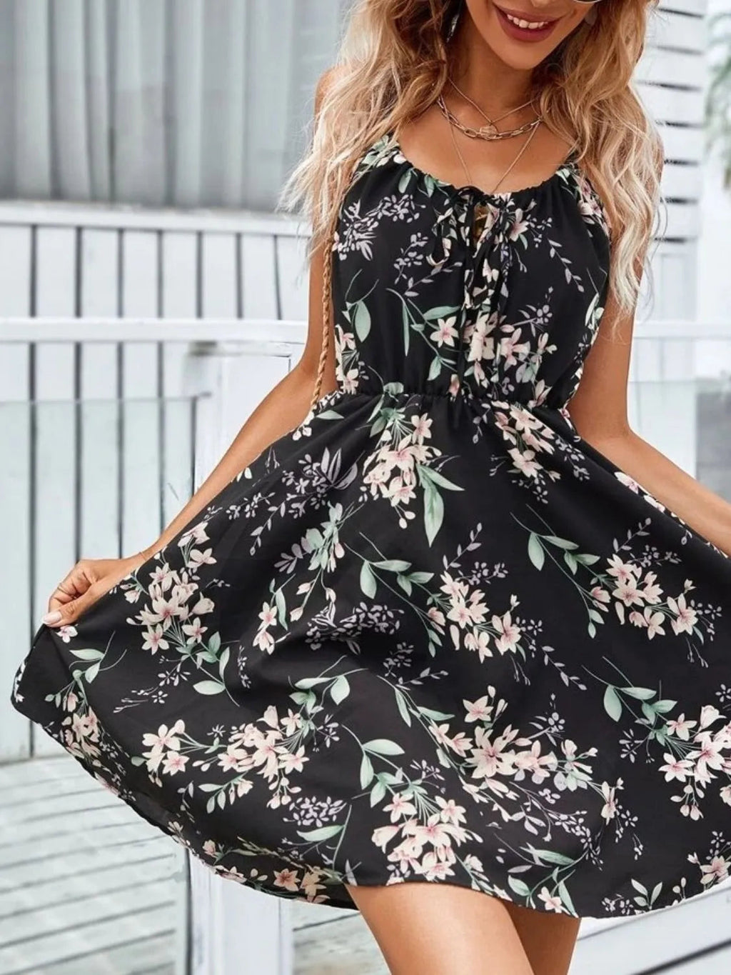 Women’s black tie-shoulder mini dress with pink floral print and gathered waist