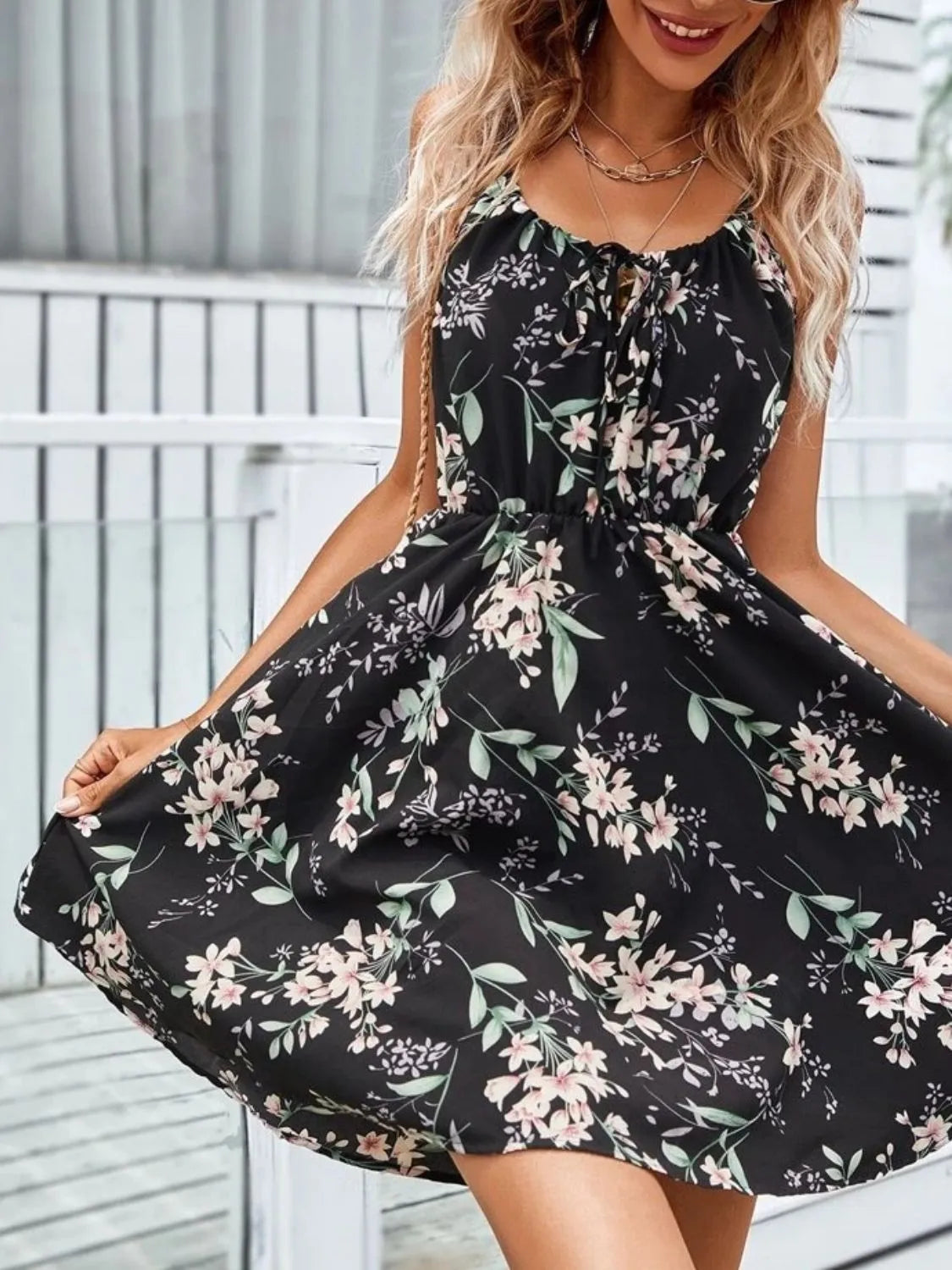 Women’s black tie-shoulder mini dress with pink floral print and gathered waist